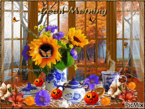 GOOD MORNING. TABLE SET WITH BLUE AND WHITE CHINA, FALL LEAVES FALLING OUT SIDE SUNFLOWERS AND ORANGE SPARKLES LITTLE JACK-O-LANTERNS ORANGES ANF ORANGE BUTTERFLIES. - Gratis geanimeerde GIF