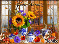 GOOD MORNING. TABLE SET WITH BLUE AND WHITE CHINA, FALL LEAVES FALLING OUT SIDE SUNFLOWERS AND ORANGE SPARKLES LITTLE JACK-O-LANTERNS ORANGES ANF ORANGE BUTTERFLIES. GIF animado
