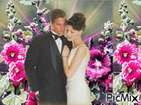 Virágos háttérben szerelmes pár. - GIF animado gratis